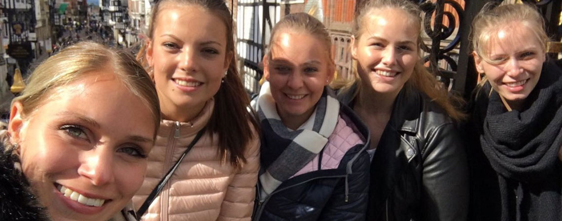 Fünf lächelnde Schülerinnen der Erich-Bracher-Schule bei ihrem Erasmus-Aufenthalt in Chester, England.